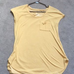 Long yellow shirt with a pocket and short sleeves.